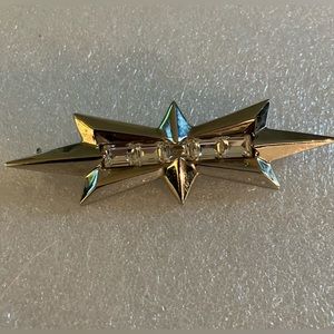 Vintage signed Thierry Mugler chrome colored crystal star brooch.